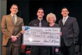  ?? PHOTO BY CHLOE ELMER - FOR DIGITAL FIRST MEDIA ?? During the ceremony, family members of Chief John J. McGowan III, presented a check for a $3,500 scholarshi­p named in his memory to Brett Beaumont of Bensalem.