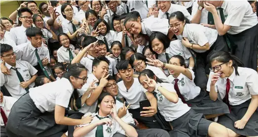  ??  ?? Teen sensation: Ismail taking a wefie with the excited students at SM Stella Maris. — AZMAN GHANI / The Star