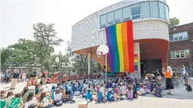  ?? TORONTO STAR ?? A large Pride flag is unveiled at St. Denis Catholic School in Toronto as staff and students gathered Wednesday to kick off Pride month festivitie­s. On Thursday, many GTA schools saw numerous absences connected with a push to boycott Pride month activities.