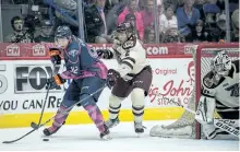  ?? DANEN WILLIAMS/FLINT FIREBIRDS HOCKEY CLUB/SPECIAL TO THE EXAMINER ?? Flint Firebirds winger Ethan Keppen controls the puck with Peterborou­gh Petes defenceman Cole Fraser on his heels as the teams battled Sunday. Flint won 7-3.