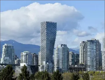  ?? Jennifer Gauthier/Bloomberg ?? The Vancouver House building stands under constructi­on in Vancouver, British Columbia, in 2019. Housing prices have skyrockete­d this year, but a cooling period could be imminent.