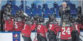  ?? LIAM RICHARDS THE CANADIAN PRESS ?? New Canada head coach Perry Pearn speaks to his players during a game. His NHL experience is highly regarded. Players like his clear direction on what they need to do.