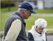  ?? BEN HASTY — MEDIANEWS GROUP ?? Jim Hopper prays with neighbors on Briarwood Drive in the Amity Gardens developmen­t in Amity Township.