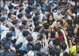  ?? AP ?? Pro-democracy activists scuffle with police on the road to the Government House in Hong Kong Tuesday.