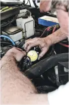  ??  ?? Technician Erick Brown mounted a dial indicator on the pump that extended down into the pump and measures pump camshaft lift. This will be used to determine timing.