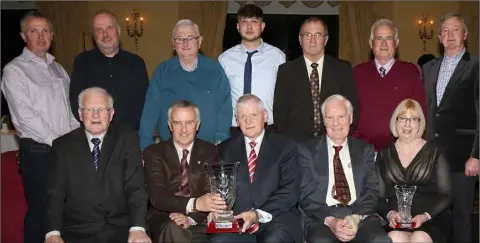  ??  ?? Sheamus Howlin accepts the club of the year award from special guest Jim Bolger as his St. Martin’s colleagues look on.