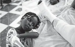  ?? MATIAS DELACROIX/AP ?? Younaika rests next to her mother Jertha Ylet on Sunday at the General Hospital of Les Cayes. Her mother was injured in the earthquake that destroyed their home.