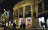  ?? PAMELA HASSELL — THE ASSOCIATED PRESS ?? People walk near the Versace boutique on Rodeo Drive in Beverly Hills on Monday.