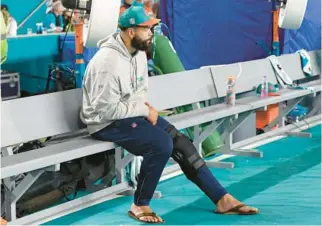  ?? JOHN MCCALL/SOUTH FLORIDA SUN SENTINEL ?? Dolphins offensive lineman Connor Williams sits on the bench Dec. 11 after exiting the game against the Titans with a left knee injury at Hard Rock Stadium in Miami Gardens.