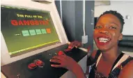  ?? Picture: ESA ALEXANDER ?? INITIATIVE: Engineerin­g student Regina Kgatle shows how to play her arcade game, ’The Pull of the Gangster’, at Friends of Design — Academy of Digital Arts, in Cape Town