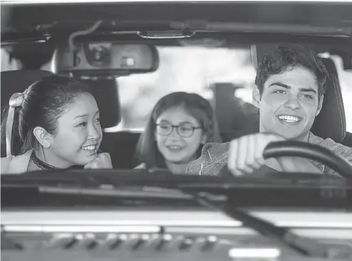  ?? NETFLIX ?? From left, Lana Condor and Noah Centineo share a personal moment in Netflix’s popular teen romantic comedy To All the Boys I’ve Loved Before.