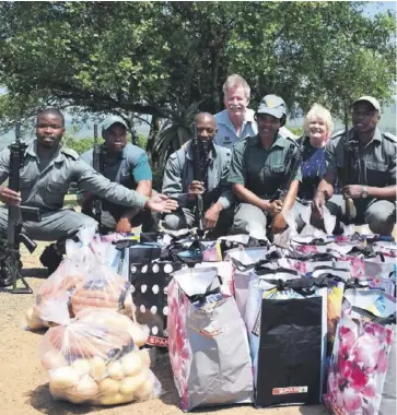  ??  ?? Honorary Officers from HiP with field rangers at the handover of Spar hampers last weekend