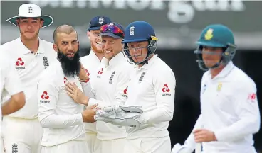  ?? /Reuters ?? Spin wizard: England's Moeen Ali, second left, is congratula­ted by teammates after taking the wicket of SA’s Quinton de Kock, right, at Lord’s on Sunday. Off-spinner Ali took a career best of 10/112 in the match.