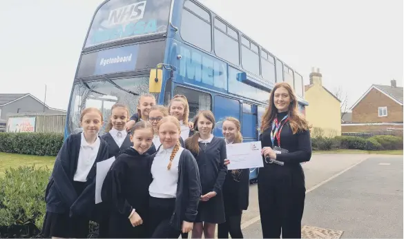  ?? ?? Hetton Lyons Primary School pupils with NHS Careers Programme Coordinato­r, Laura Watkins, outside the Melissa bus.