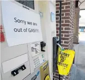  ?? MIC SMITH/AP ?? Left, Robert Barker loads his truck with bottled water and gas in New Bern, N.C. Above, a gas station in Mt. Pleasant, S.C., alerts motorists that it is out of gas. About 1.7 million people in three states are being told to evacuate in advance of the arrival of Hurricane Florence later this week.