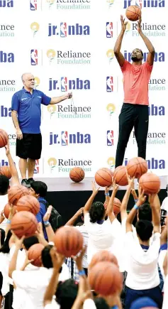  ?? — AFP photo ?? American basketball player for Golden State Warriors Kevin Durant (R) gives tips to children during an event at the NBA academy in Greater Noida, a suburb of New Delhi on July 28, 2017.