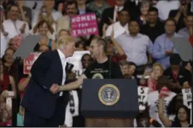  ?? CHRIS O’MEARA — ?? President Donald Trump with supporter Gene Huber during a campaign rally Saturday in Melbourne, Fla.