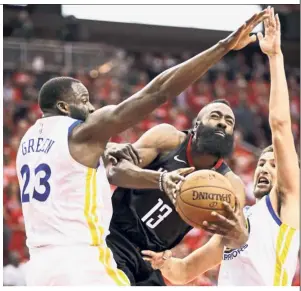  ?? — AP ?? Tearing through: Houston Rockets guard James Harden (centre) shoots between Golden State Warriors forward Draymond Green (left) and guard Klay Thompson during Game 5 of the NBA playoffs Western Conference Finals on Thursday.