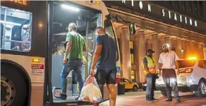  ?? ?? a group of migrants boarding a Cta bus at Chicago’s Union station to be taken to a salvation army shelter after arriving from texas recently.