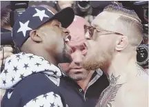  ?? AP PHOTO ?? VERBAL SPARRING SESSION: Conor McGregor, right, and Floyd Mayweather Jr. get in each other’s face in a news conference at Barclays Center on Thursday.