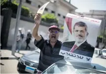  ?? Manu Brabo/the Associated Press ?? A supporter of Egypt’s ousted president Mohammed Morsi chants slogans against the Egyptian army in Cairo, Friday.