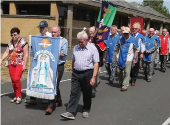  ??  ?? Sunday’s procession leaving Holy Family church.