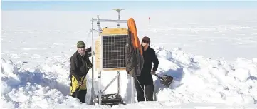  ?? — AFP photo ?? Photo shows scientists setting up equipment on Totten Glacier to measure glacial flow speed and surface elevation.