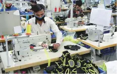  ?? ANI ?? Workers prepare sports items at Nivia sports Factory, in Jalandhar. The easing in lockdown restrictio­ns across India is starting to pay off, India’s central bank says.