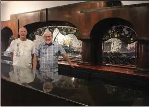  ?? The Sentinel-Record/Tanner Newton ?? FUNDRAISER: Rotarian Rollin Caristiano­s, left, who works closely with “One Block at a Time,” an orphanage in Kenya, has been planning Saturday’s fundraiser at The Legendary Vapors, managed by Tom Wilkins. The two are standing in the Vapors’ bar area.