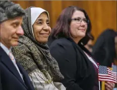  ?? Steve Mellon/Post-Gazette ?? From left, Mark Zehentner, a native of United Kingdom; Wafa Ahmed, a native of Sudan; and Jessica Prieto, a native of Germany, smile after receiving a certificat­e of citizenshi­p Friday during a naturaliza­tion ceremony at the federal courthouse, Downtown.
