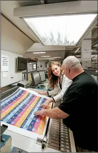  ?? Arkansas Democrat-Gazette/JOHN SYKES JR. ?? Kristi Dannelley, co-owner and president of Magna IV printing in Little Rock, works earlier this month with employee Blake Cross.