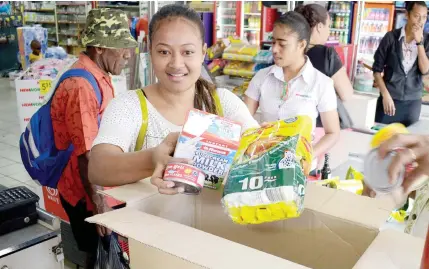  ?? Photo: Ronald Kumar. ?? Viniana Tinaidelan­ikau uses a carton to pack her groceries, instead of using a plastic bag as the levy has increased to $0.20 from $0.10 from today, August 1, 2018.