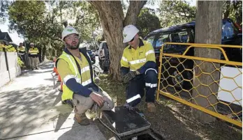  ?? PHOTO: BRENDAN ESPOSITO/AAP ?? BUSY: NBN contractor­s proceed with the rollout in Sydney yesterday.