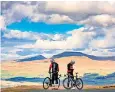  ??  ?? Two cyclists enjoying fine weather near Ingleborou­gh Fell, Ingleton, North Yorks