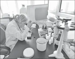  ?? PROVIDED TO CHINA DAILY ?? A forensics officer tests a DNA sample at the public security bureau in Rizhao, Shandong province.