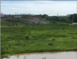  ?? RICHARD PAYERCHIN — THE MORNING JOURNAL ?? This shows the green flood plain and gray hills of slag that sit between the steel mills and the Black River in Lorain.