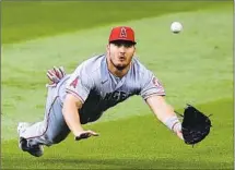  ?? Elaine Thompson Associated Press ?? ANGELS center fielder Mike Trout dives for, but misses, a fly ball from Seattle Mariners’ J.P. Crawford for a single in the third.