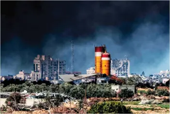  ?? — AFP photo ?? A dark smoke cloud covers damaged silos in the Gaza Strip during the ongoing conflict between Israel and the Palestinia­n militant group Hamas.