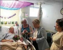 ?? ARIEL ZANGLA — DAILY FREEMAN ?? Pictured in the Intensive Care Unit of HealthAlli­ance Hospital’s Broadway Campus in Kingston on Tuesday, Aug. 21, 2018, are, from left, newlyweds Susan Schultz and Lauriann Devine; Ulster County Surrogate’s Court Judge Sara McGinty, who presided over the couple’s wedding; and Teresa Todaro, a good friend of the couple. Schultz died on Aug. 22.