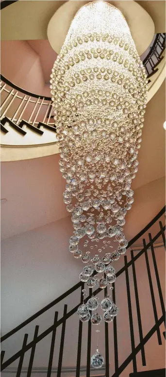  ?? P ?? A 17-foot custom Swarpvski crystal chandelier by Elegant Lighting hangs from the fourth floor.