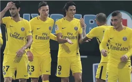  ??  ?? Paris Saint Germain’s forward Edinson Cavani, centre, celebrates with teammates after scoring against Angers Photo: AP