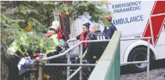  ?? SHANE MACKICHAN ?? An angler is taken to an ambulance after he and a friend were pulled from the Capilano River Sunday. One man died in hospital.