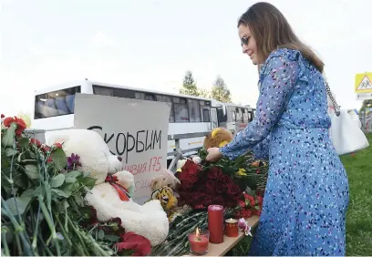  ?? Picture: AFP ?? PAYING TRIBUTE. A woman lays flowers at a makeshift memorial for victims of the shooting at School No 175 in Kazan yesterday. At least nine people, most of them children, were killed.