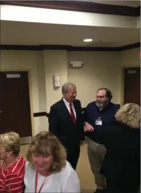  ?? MICHAEL RELLAHAN — DIGITAL FIRST MEDIA ?? The line of those waiting to say goodbye and good luck to Mark Rupsis, outgoing Chester County chief operating officer, in foreground.