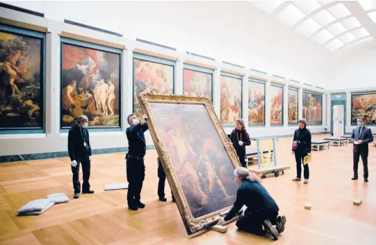  ?? DMITRY KOSTYUKOV/THE NEW YORK TIMES PHOTOS ?? Anthony van Dyck’s“Venus Asks Vulcan to Cast Arms for Her Son Aeneas”is moved by workers in January at the Louvre in Paris.