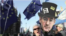  ?? | AP ?? AN EU supporter holds up a placard showing the face of a prominent British MP and leave the EU supporter Jacob Rees-Mogg, during a demonstrat­ion in London, this week.