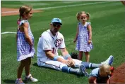  ?? AP PHOTO BY NICK WASS ?? In this June 16, 2019, file photo, Washington Nationals’ Ryan Zimmerman, center, sits on the field with his daughters Mackenzie, left, and Hayden, right, before a baseball game against the Arizona Diamondbac­ks in Washington. With baseball on hold because of the coronaviru­s pandemic, Zimmerman occasional­ly will offer his thoughts via diary entries published by the AP, while waiting for the 2020 season to begin.