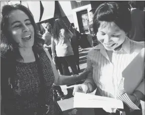  ?? LAURA A. ODA/ STAFF ?? Joanna Joseph, of Emeryville, right, celebrates with friend Marci Dillon after becoming a U. S. citizen at a naturaliza­tion ceremony at Oakland’s Paramount Theatre on Tuesday. Joseph, a native of the Philippine­s, was able to register and vote in...