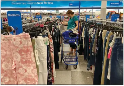  ?? (AP) ?? A shopper looks at clothing at a store in Morton Grove, Ill., in July. U.S. consumer spending accelerate­d in August despite the surge in covid-19 cases, while the additional demand combined with supply shortages kept inflation high.