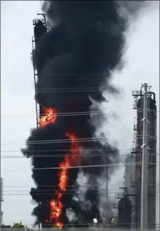  ??  ?? Flames and smoke rise after a fire started at an Exxon Mobil facility, on Wednesday, in Baytown, Texas. YI-CHIN LEE/HOUSTON CHRONICLE VIA AP